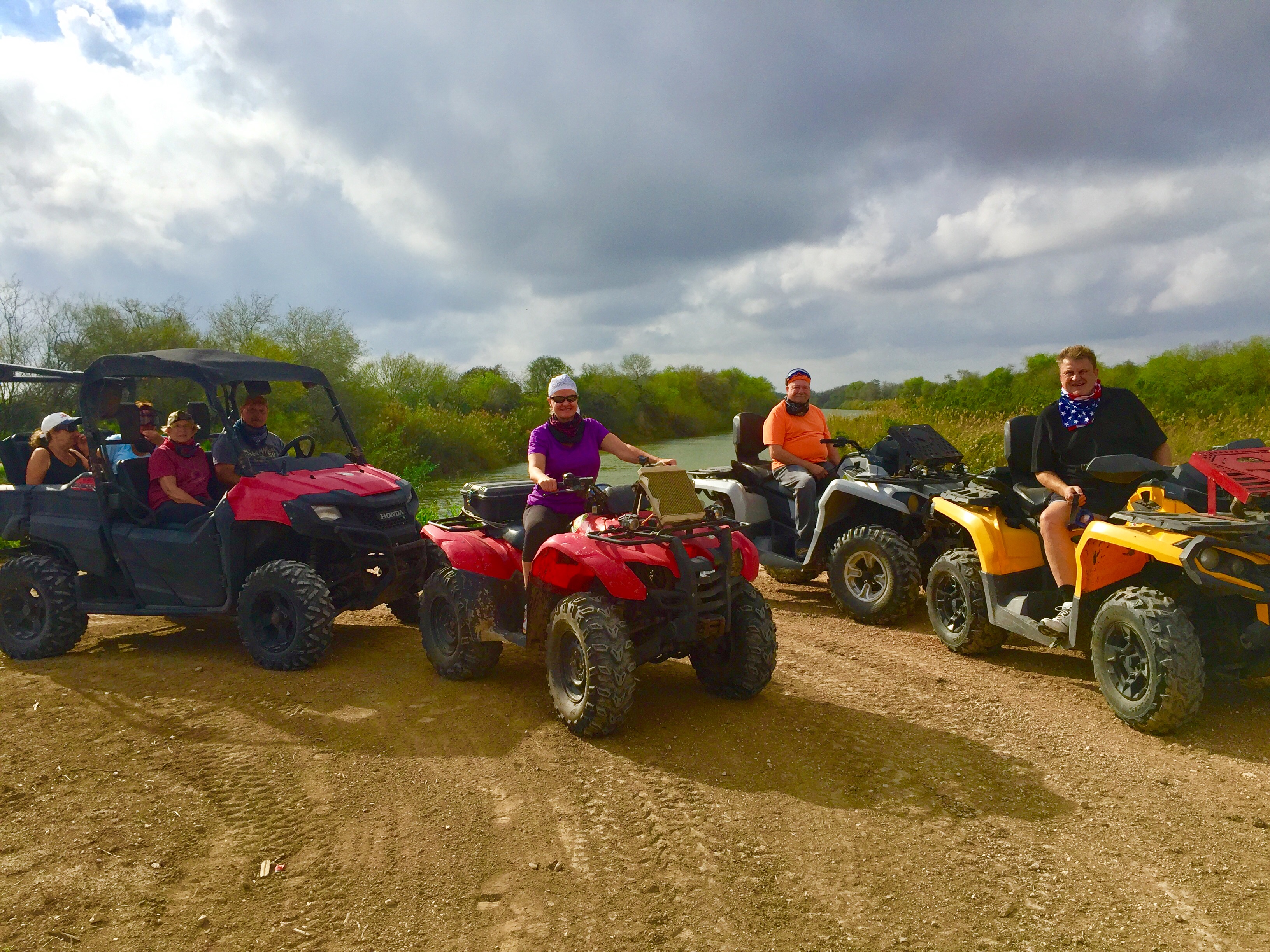 A group of winter Texans are riding Atvs by the Rio Grande River